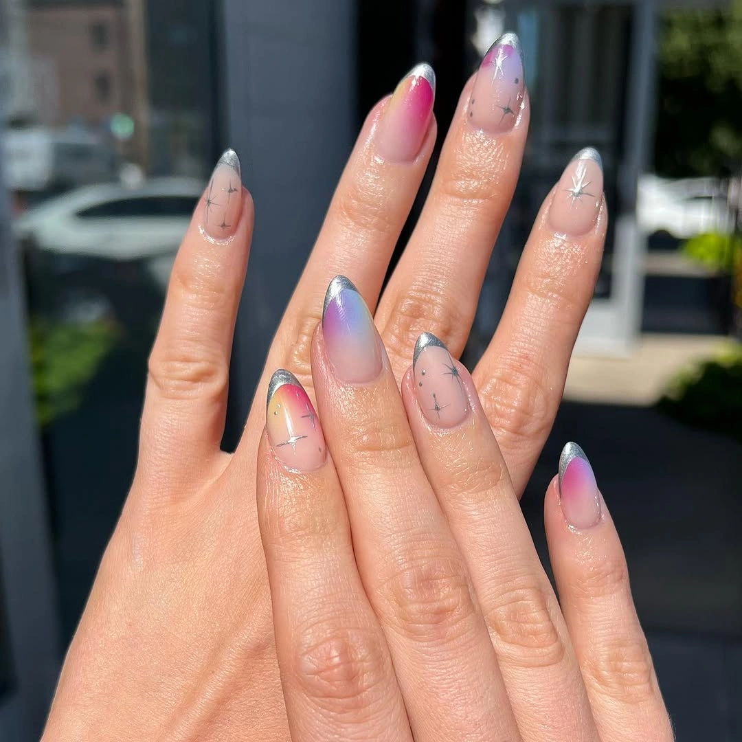 Sheer blush almond nails with slim dark linework and pale reflective tips
