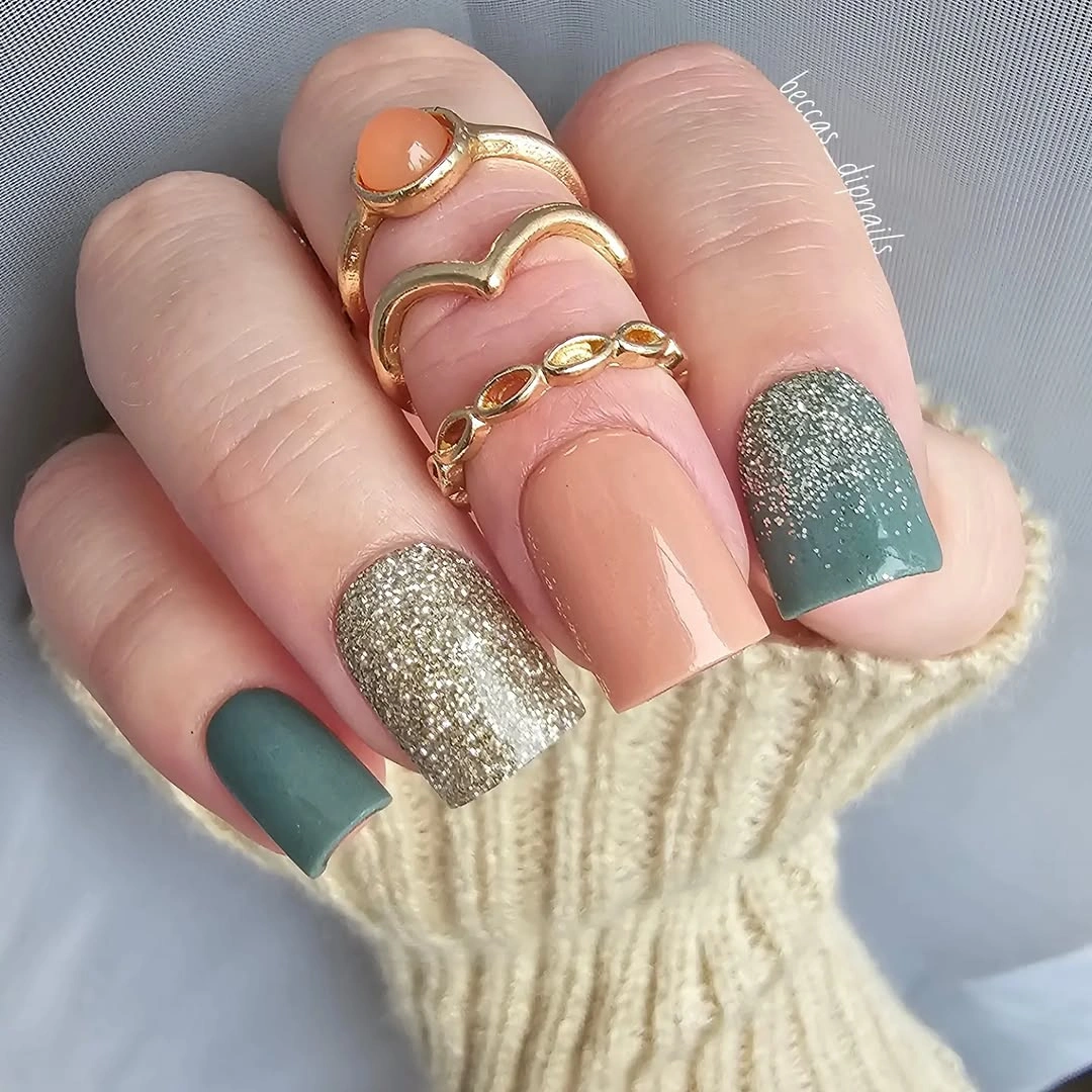 Short square nails in nude sage green and silver sparkle-like finish