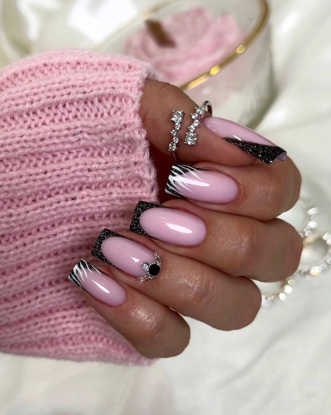 Soft pink almond nails with black and white French tips
