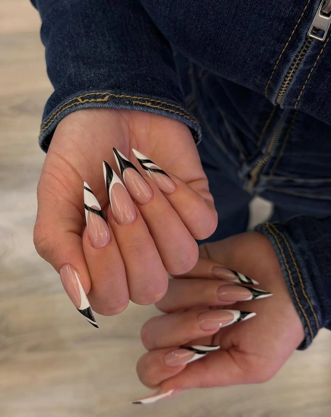 Long stiletto nails with diagonal black and white French strokes