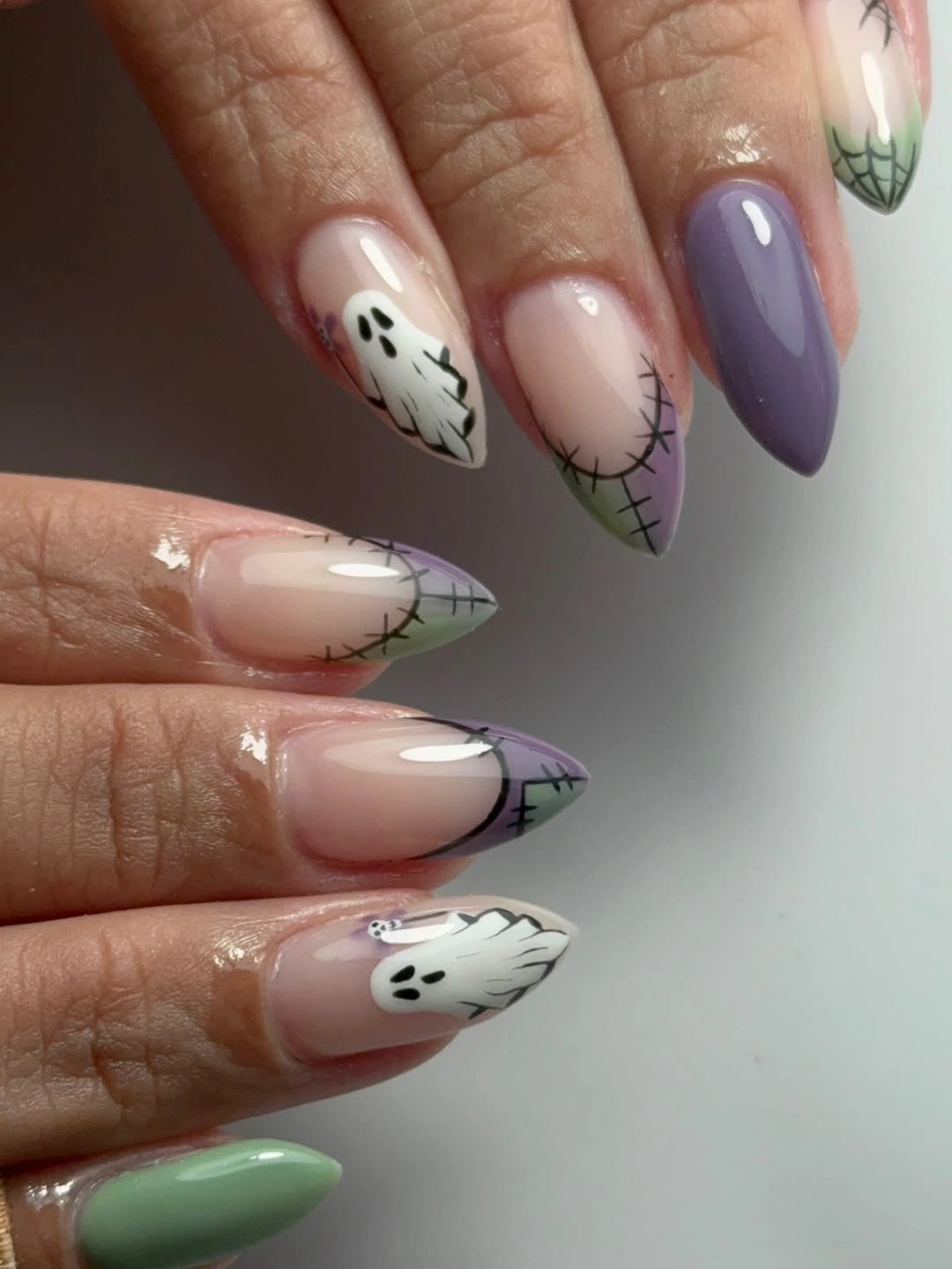 Pastel almond nails with lavender green and graphic tips