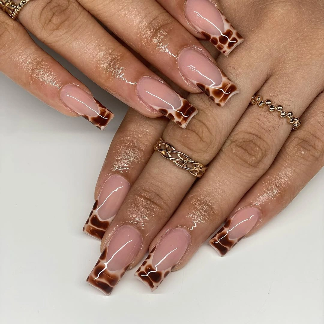 Sheer square nails with brown patterned French tip panels