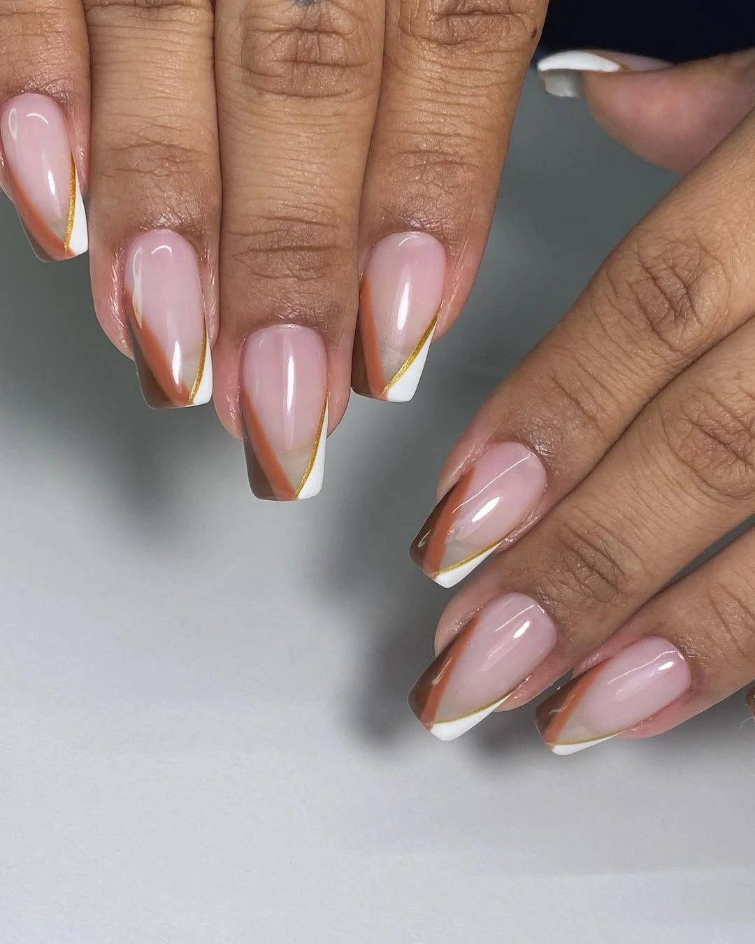 Medium almond nails with alternating green brown and white tips