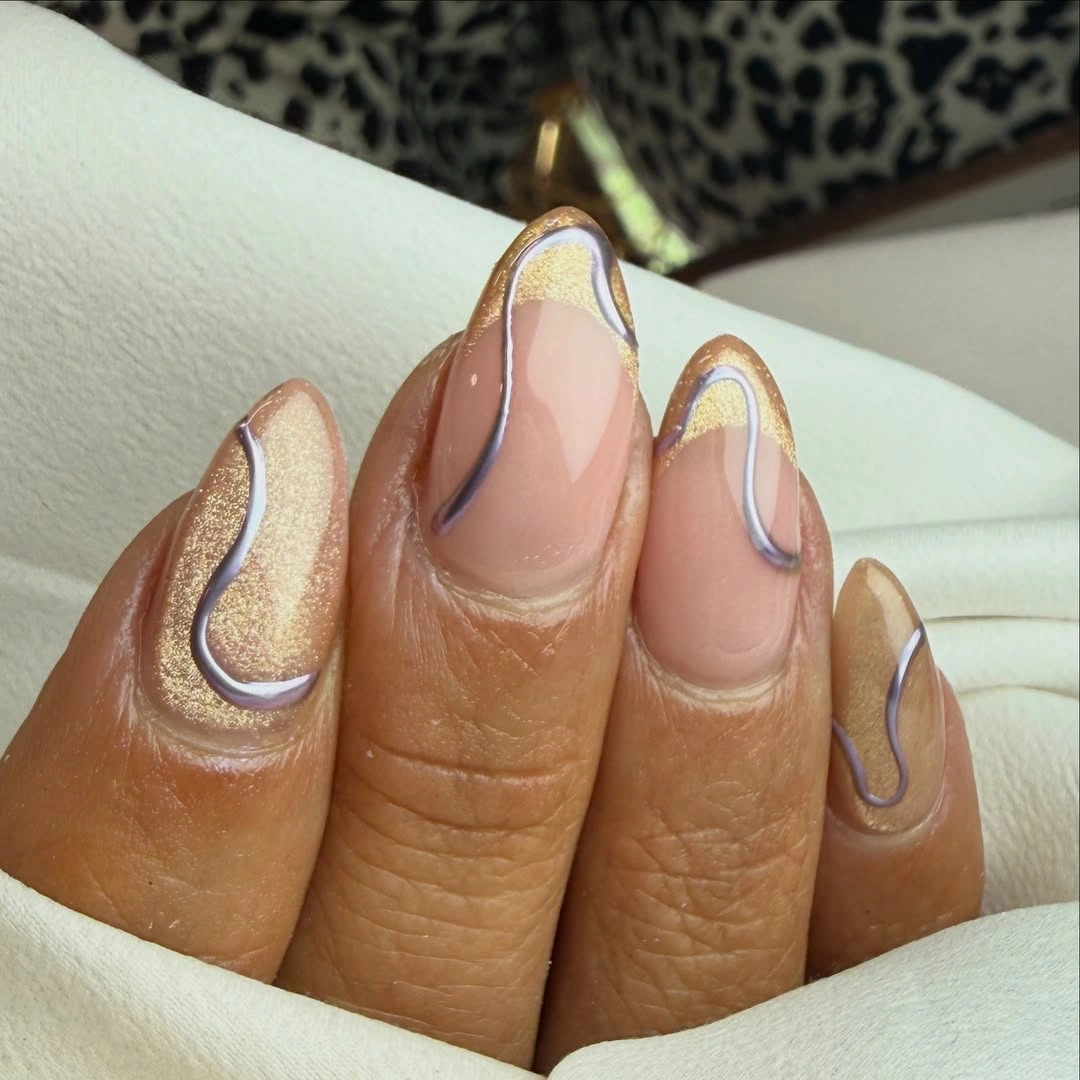 Neutral almond nails with silver and gold glitter curves