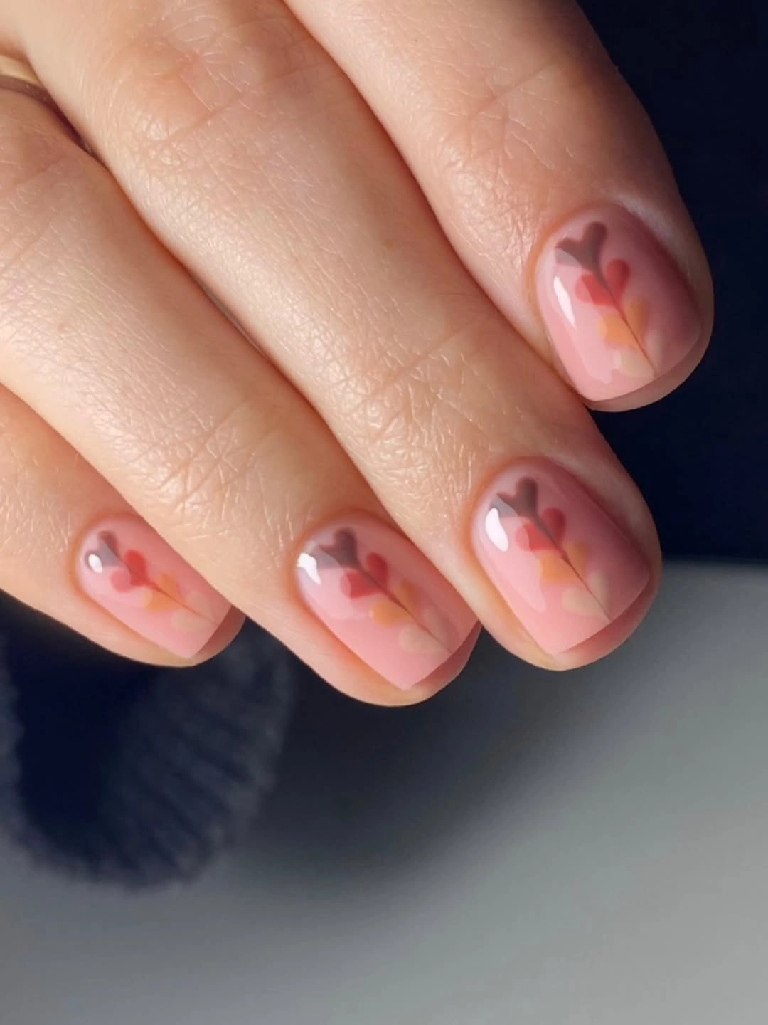 Short blush nails with soft coral abstract flower marks