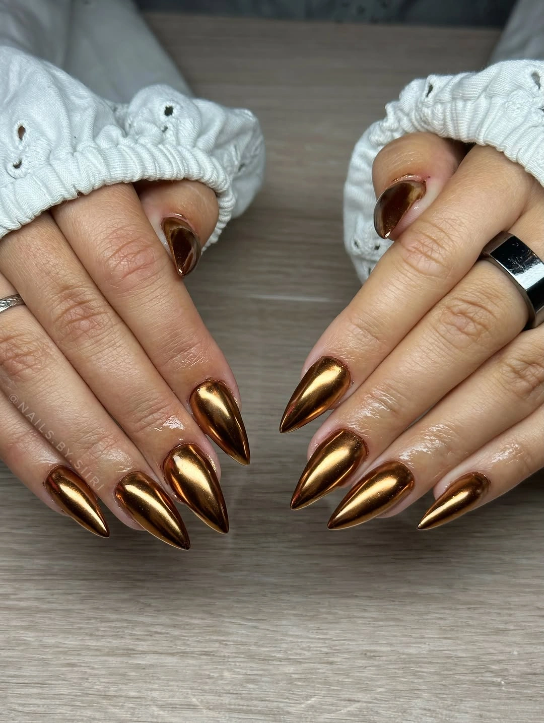 Very long pointed nails in uniform metallic bronze copper