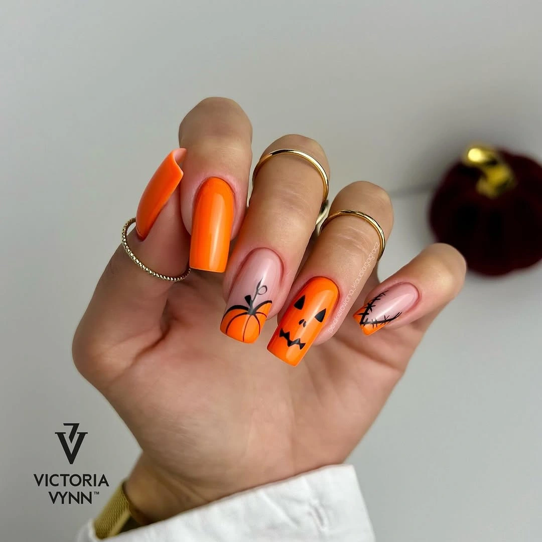 Orange almond nails with nude pumpkin and seasonal accents