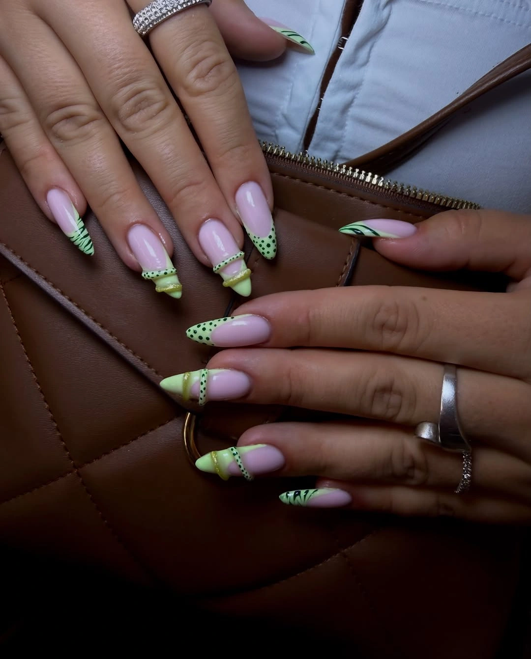 Pale pink almond nails with bright green tips and dot accents