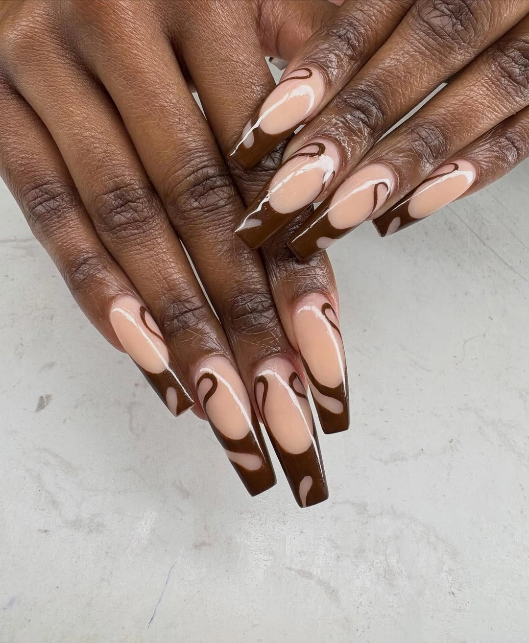 Long square nails with chocolate brown and creamy nude swirls