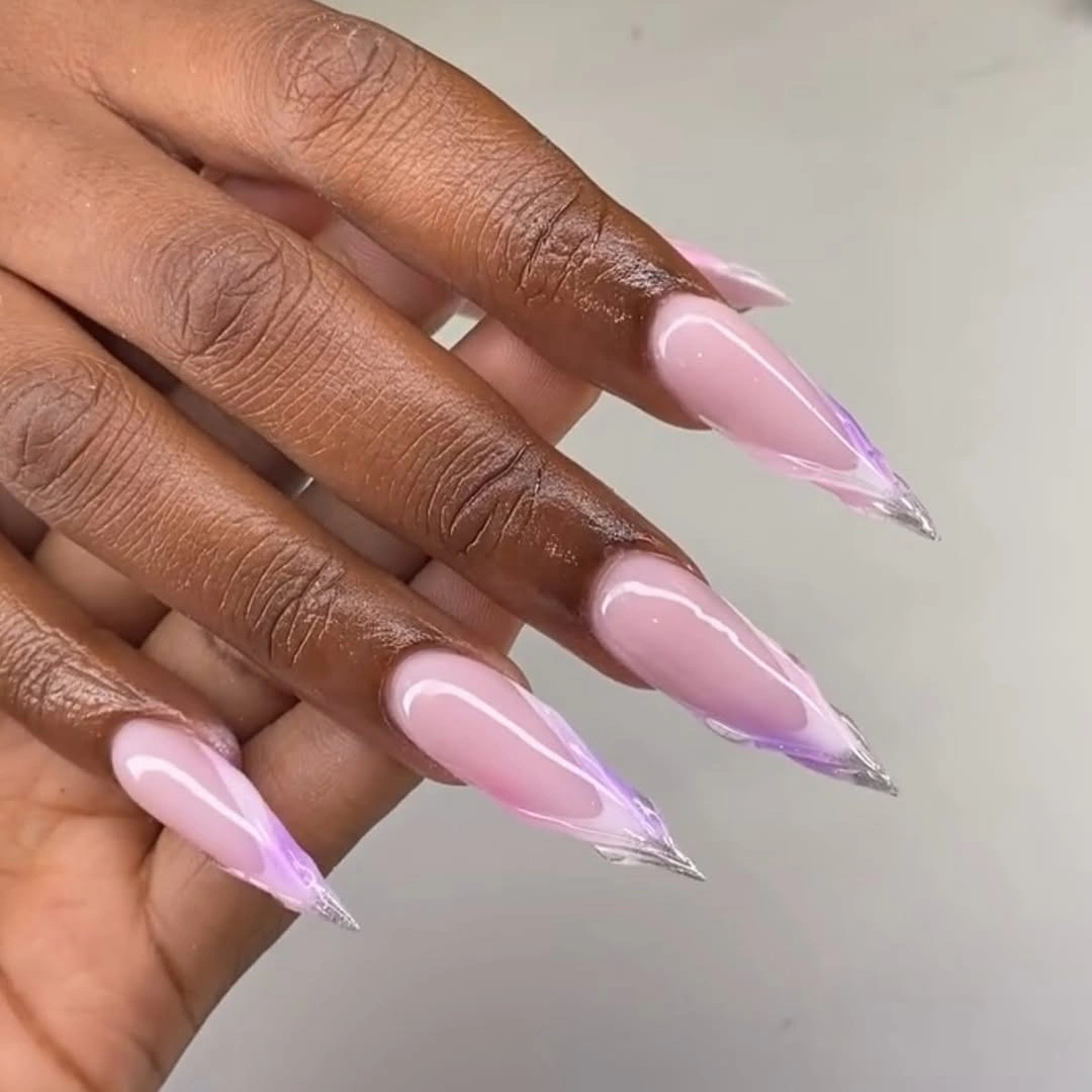 Very long glossy pink stiletto nails in a single color