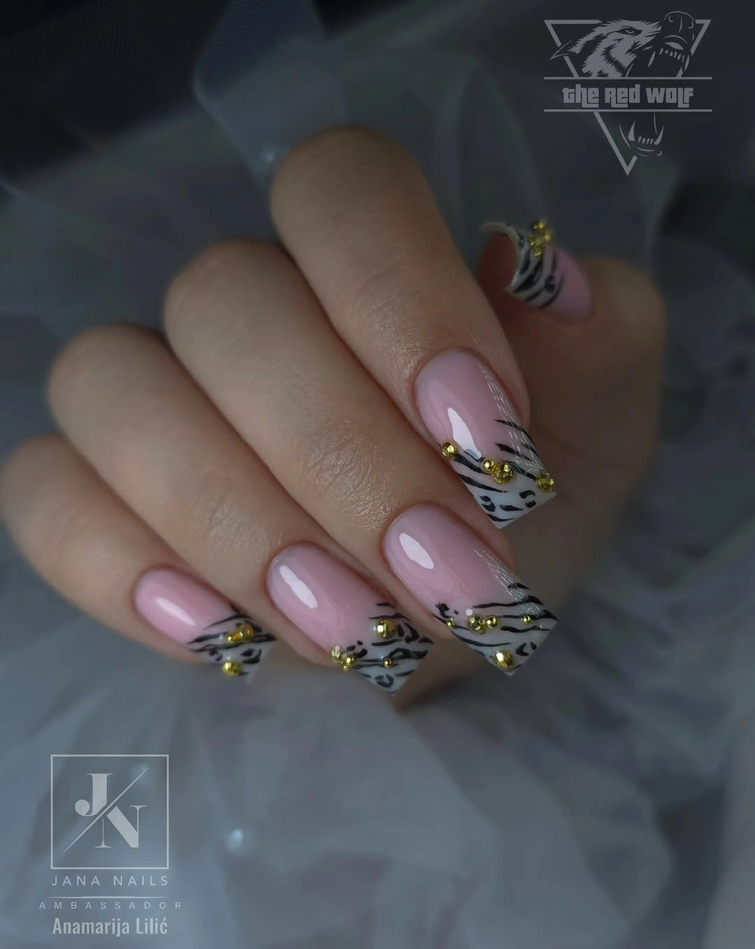 Long pale pink nails with silver edging and one colorful accent