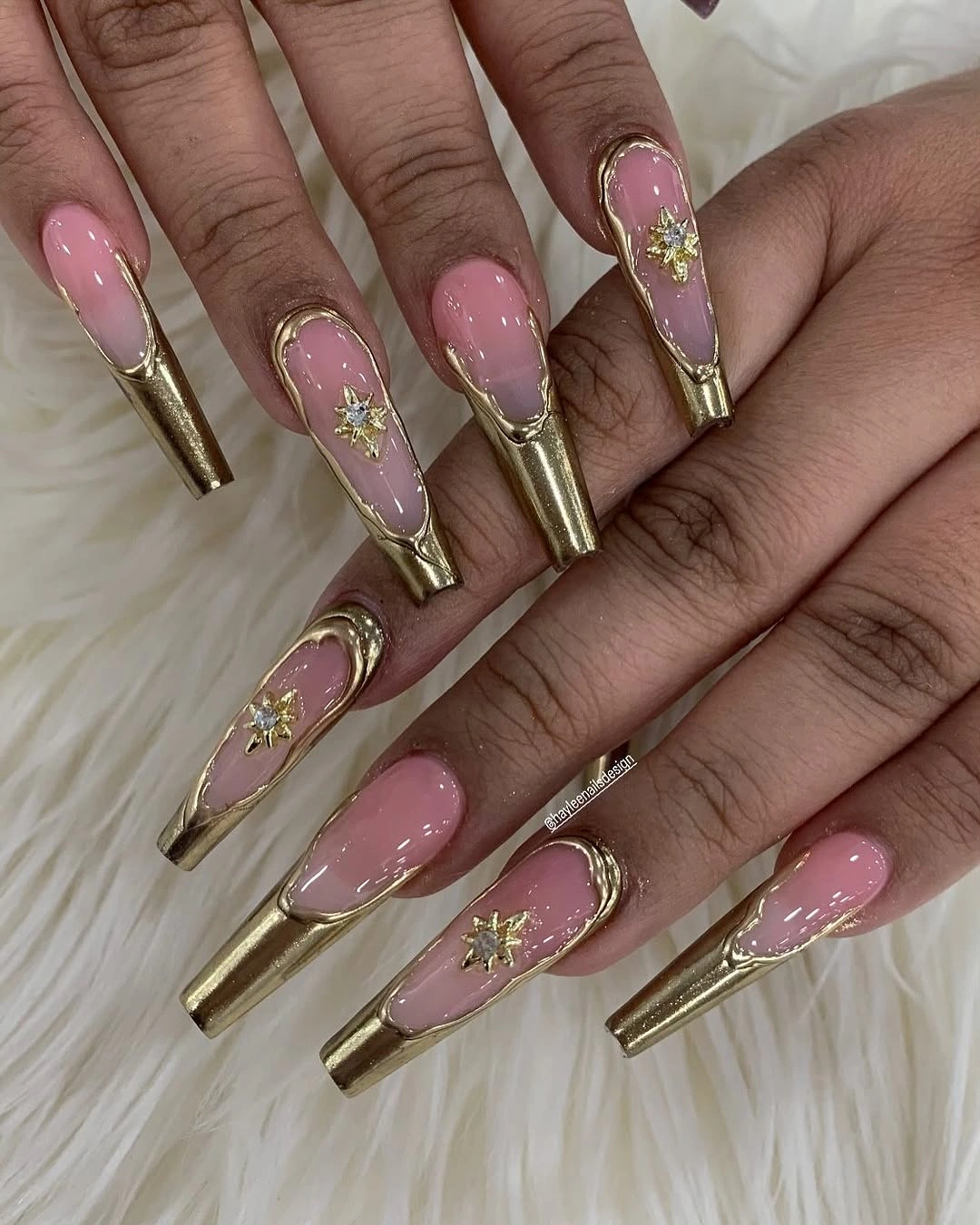 Extra long pink coffin nails with gold tips and ornate accents