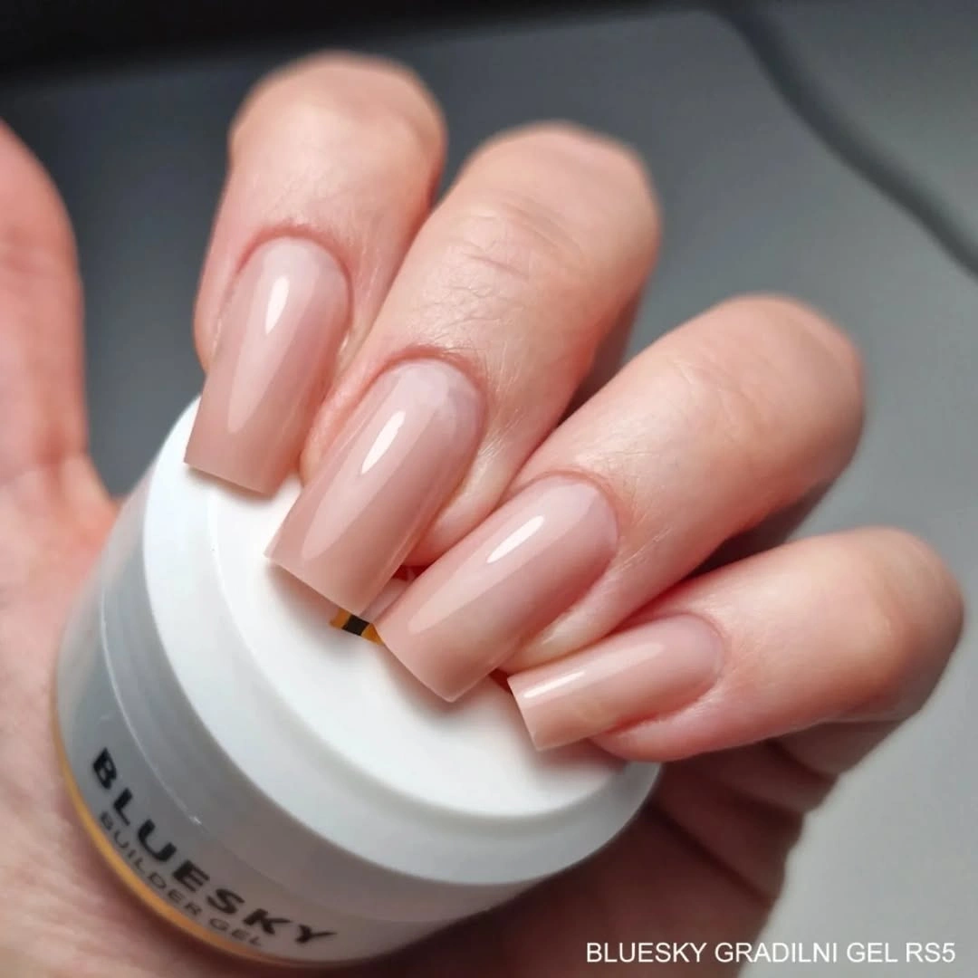 Glossy sheer peach nails with softly tapered square edges