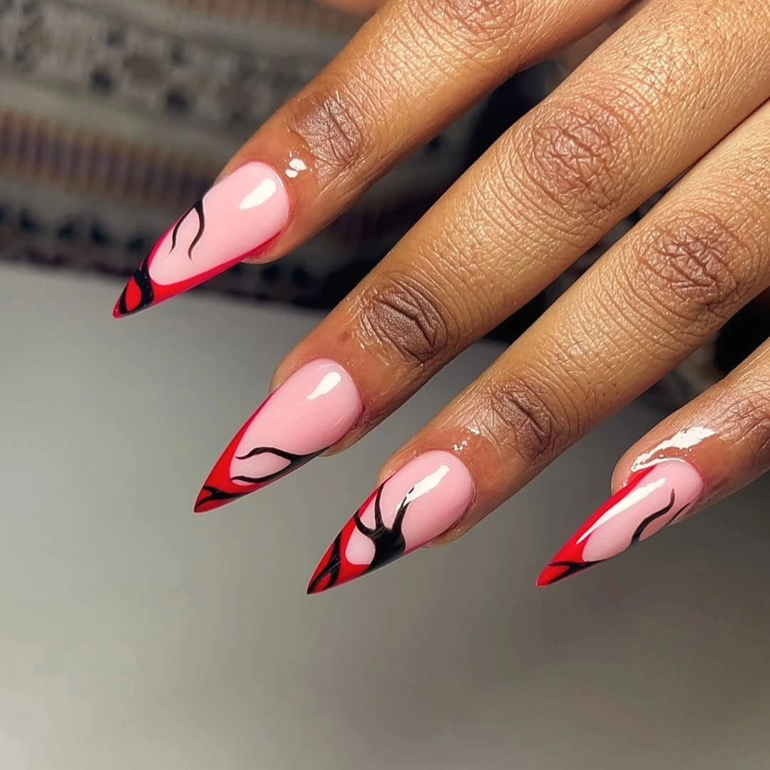 Long almond nails with red French tips and black curved line art