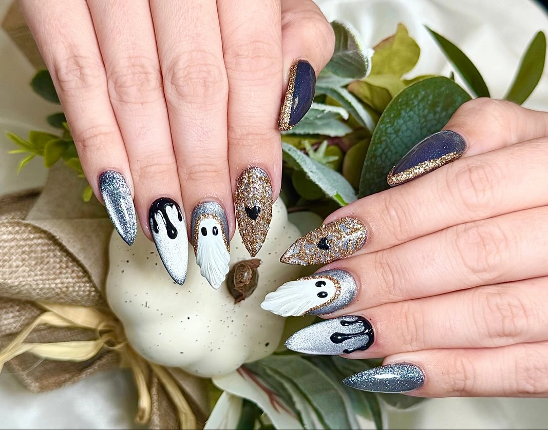 Long pointed nails with black spots white accents dark blue and silver