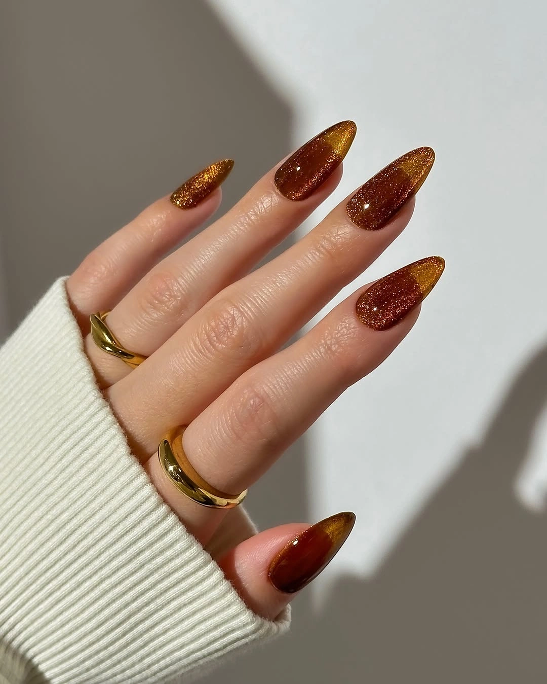 Long almond nails in dense glittering amber brown color