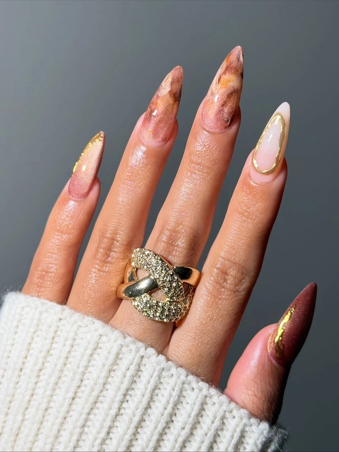 Long almond nails mixing pink peach amber panels and gold accents