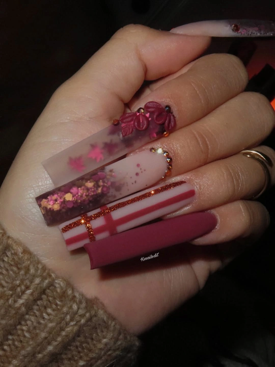 Long square pink nails with floral glitter and striped panels