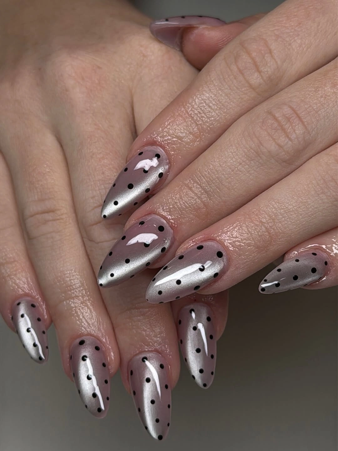 Pale mauve almond nails with silver edges and black dots