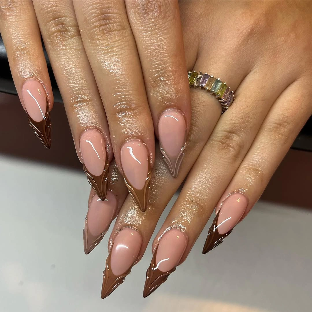 Long nude almond nails with reflective metallic brown tips