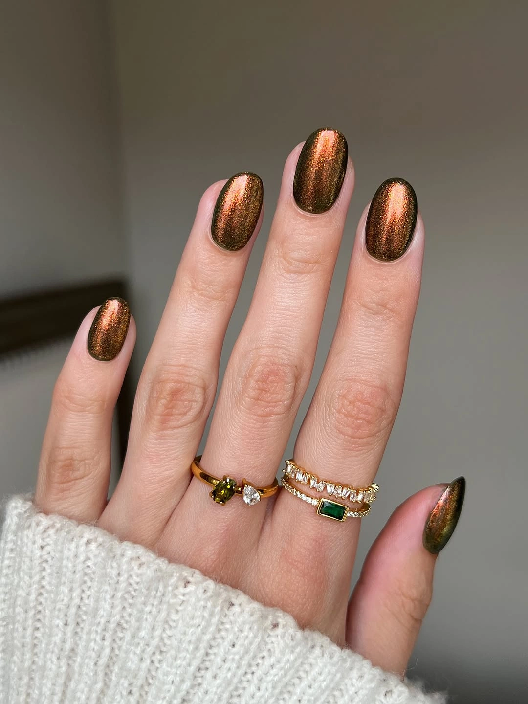 Medium almond nails in a reflective copper brown shade