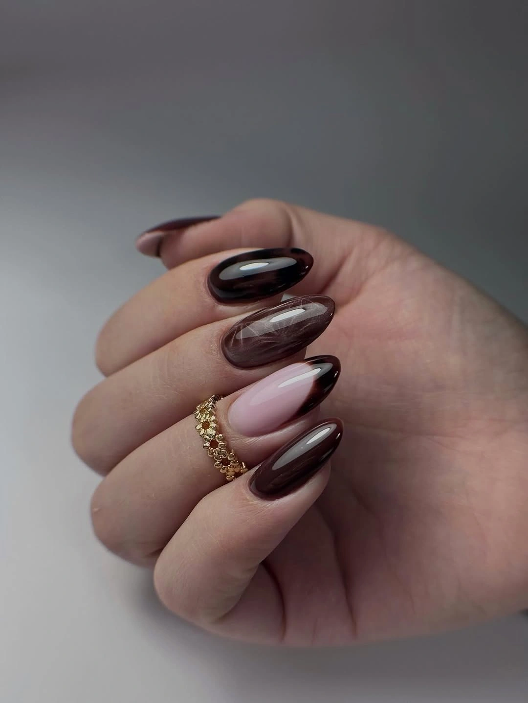 Glossy espresso and burgundy almond nails with tonal depth