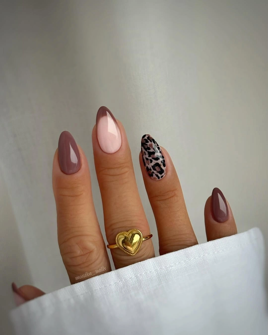 Cocoa brown almond nails with sheer pink sections and spotted accent