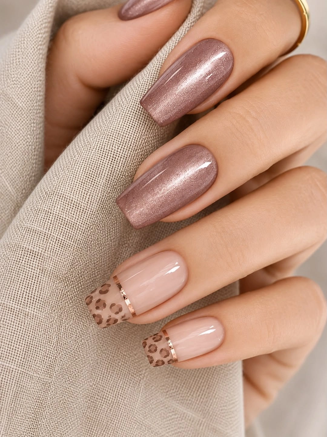 Mauve square nails with one tan and brown printed French tip