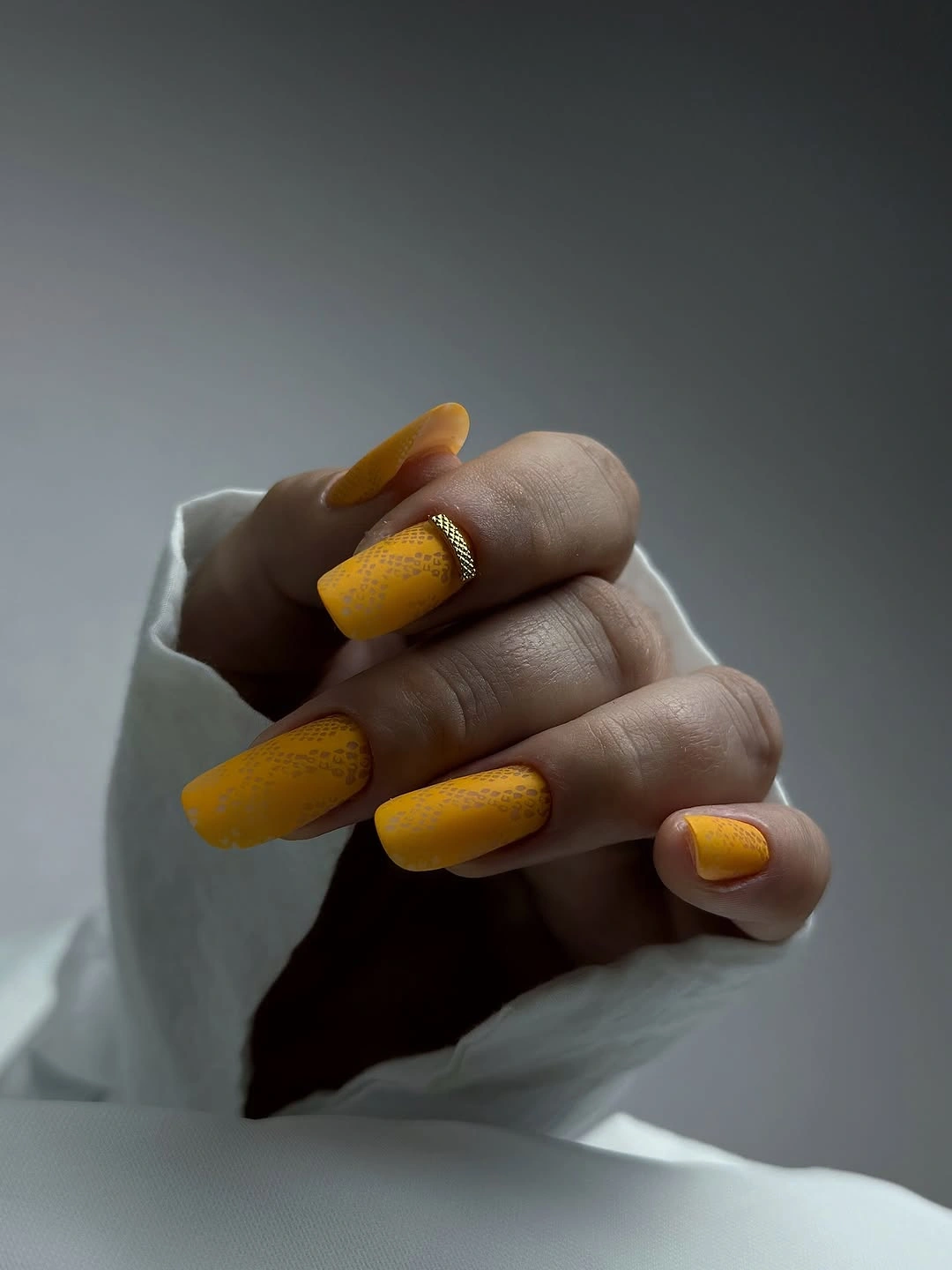 Long square mustard matte nails with delicate dark speckles
