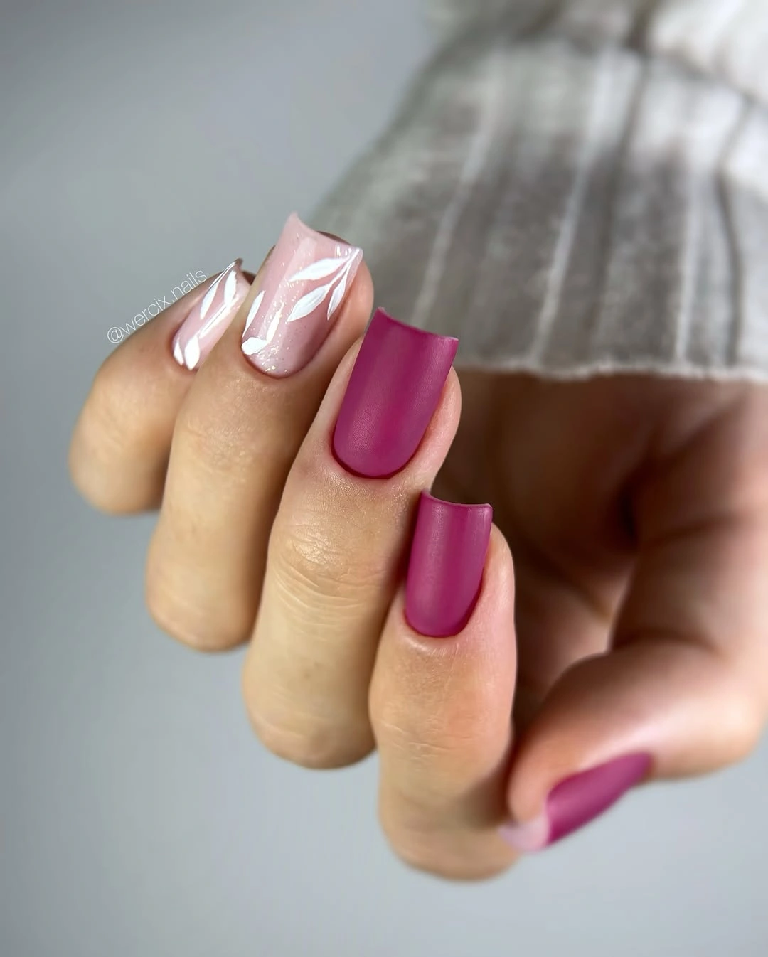 Berry pink matte nails with sparse pale botanical accents