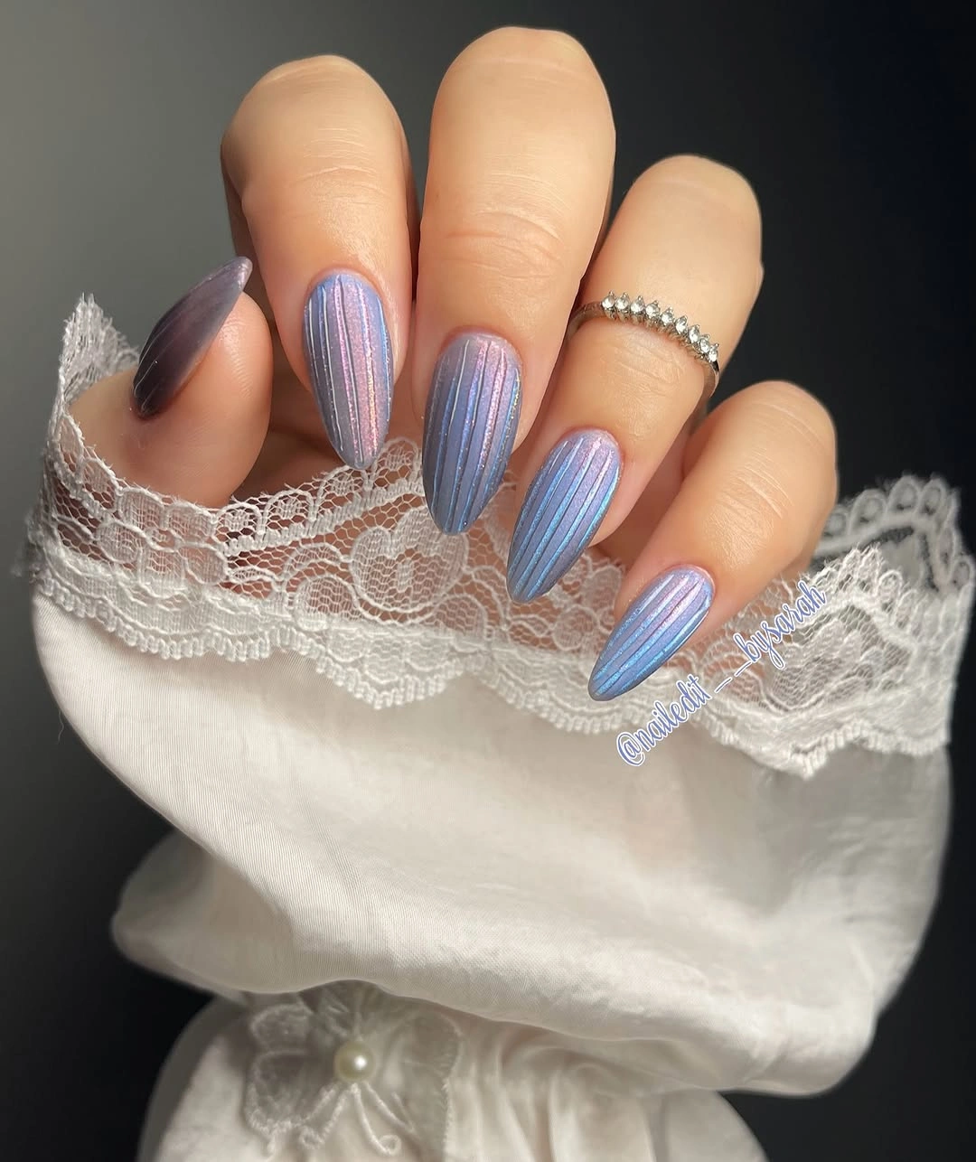 Long lavender blue stiletto nails with fine vertical shimmer lines