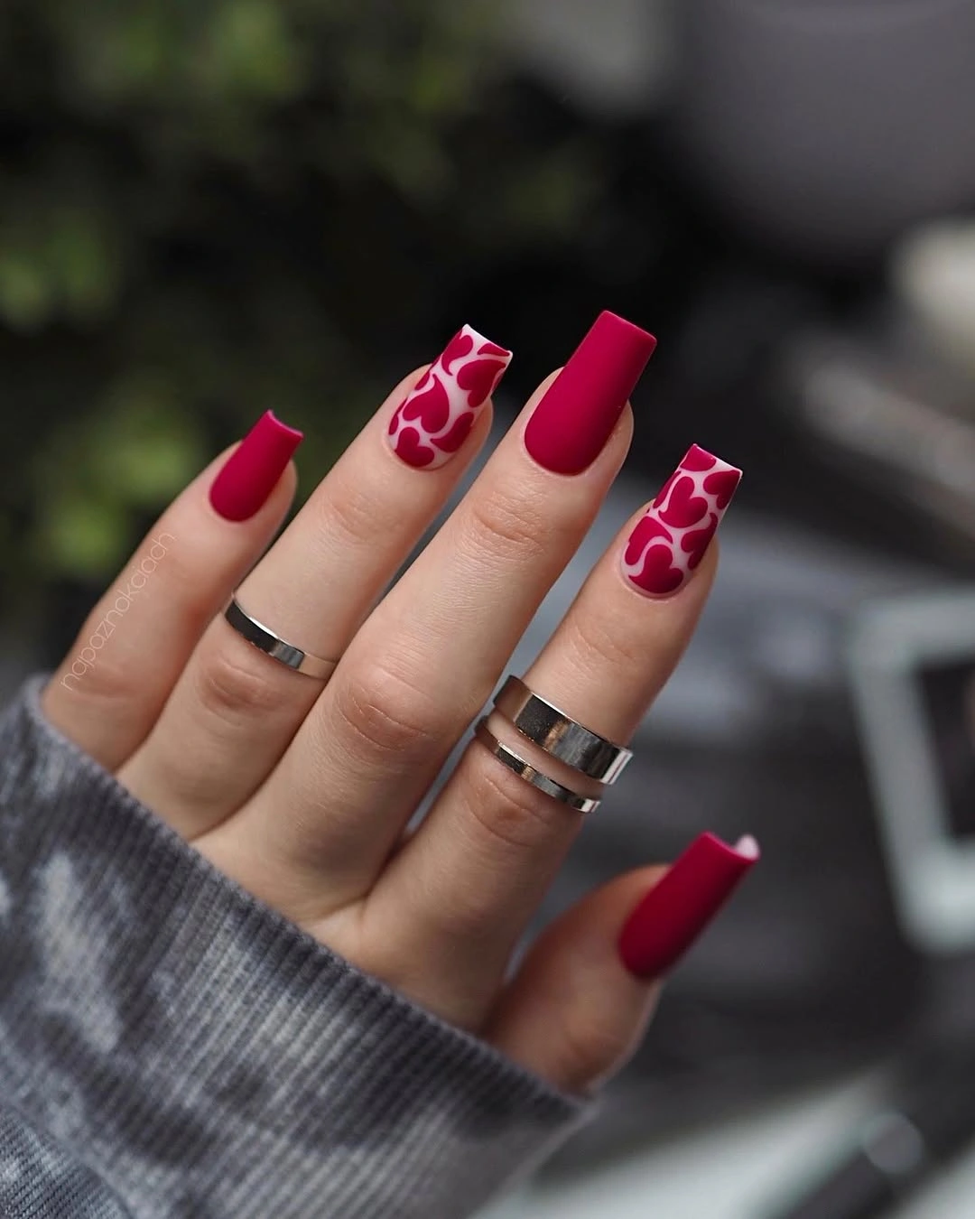 Long red matte nails with coordinated white abstract accent panels
