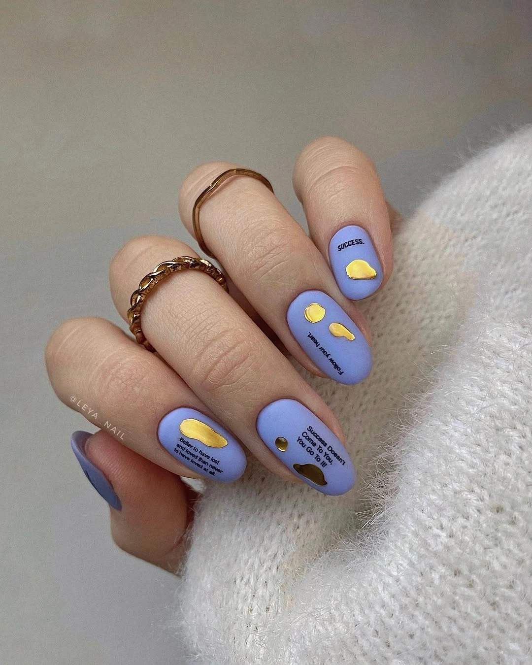 Short lavender matte nails with small yellow dots and dark details