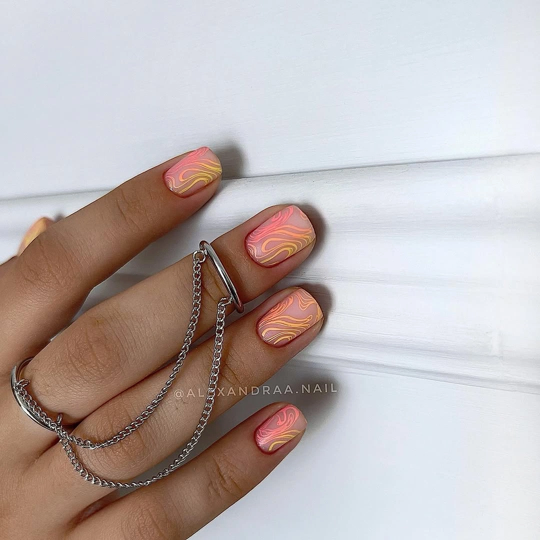 Short coral matte nails with layered yellow and pink wave lines