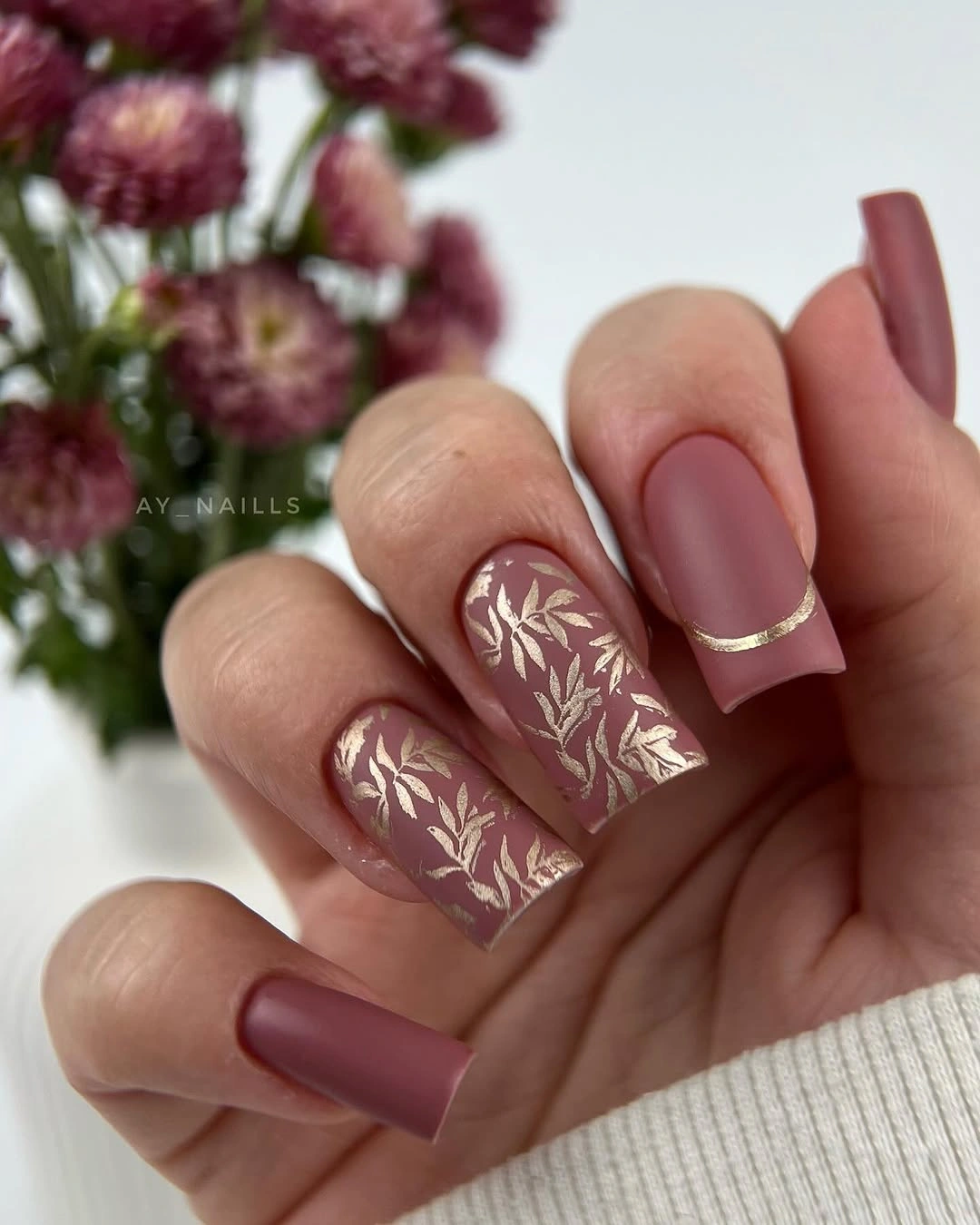 Long mauve coffin nails with pale botanical art and fine gold edges