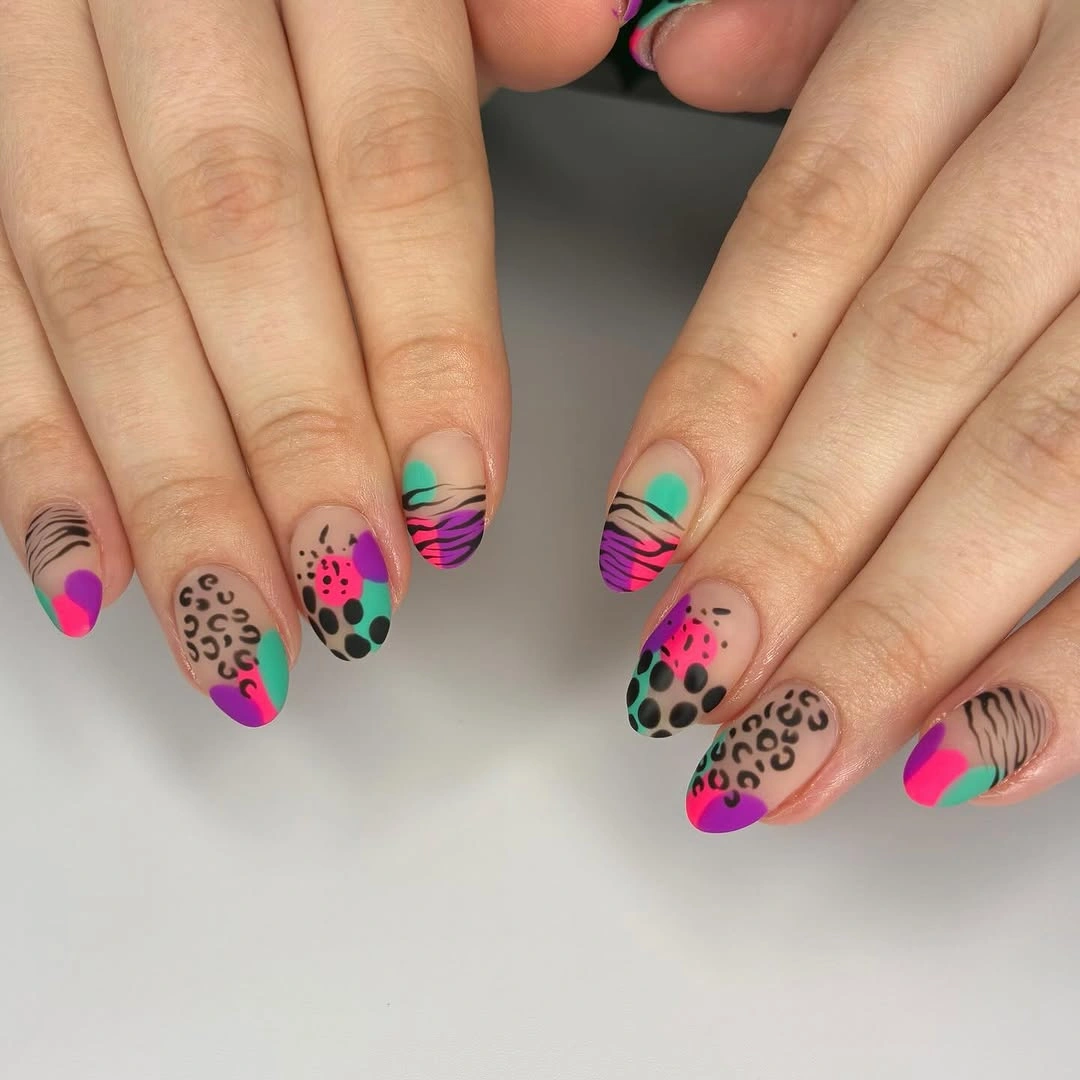 Short bright multicolor nails with waves dots and animal-print accents