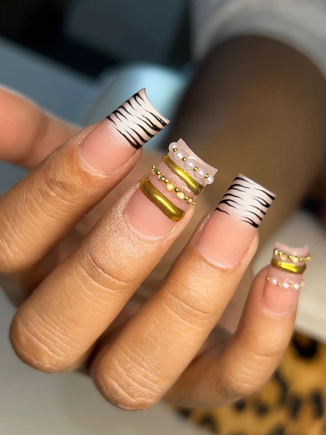 Almond nails with striped white tips and small gold bands