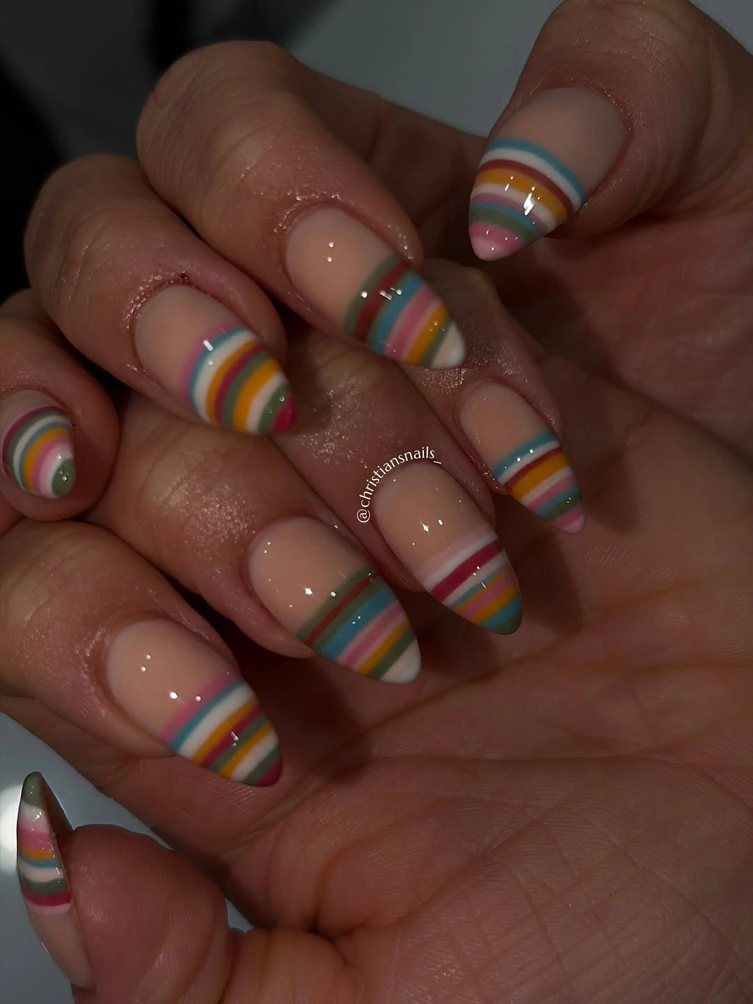 Almond nails with layered multicolor curved French stripes