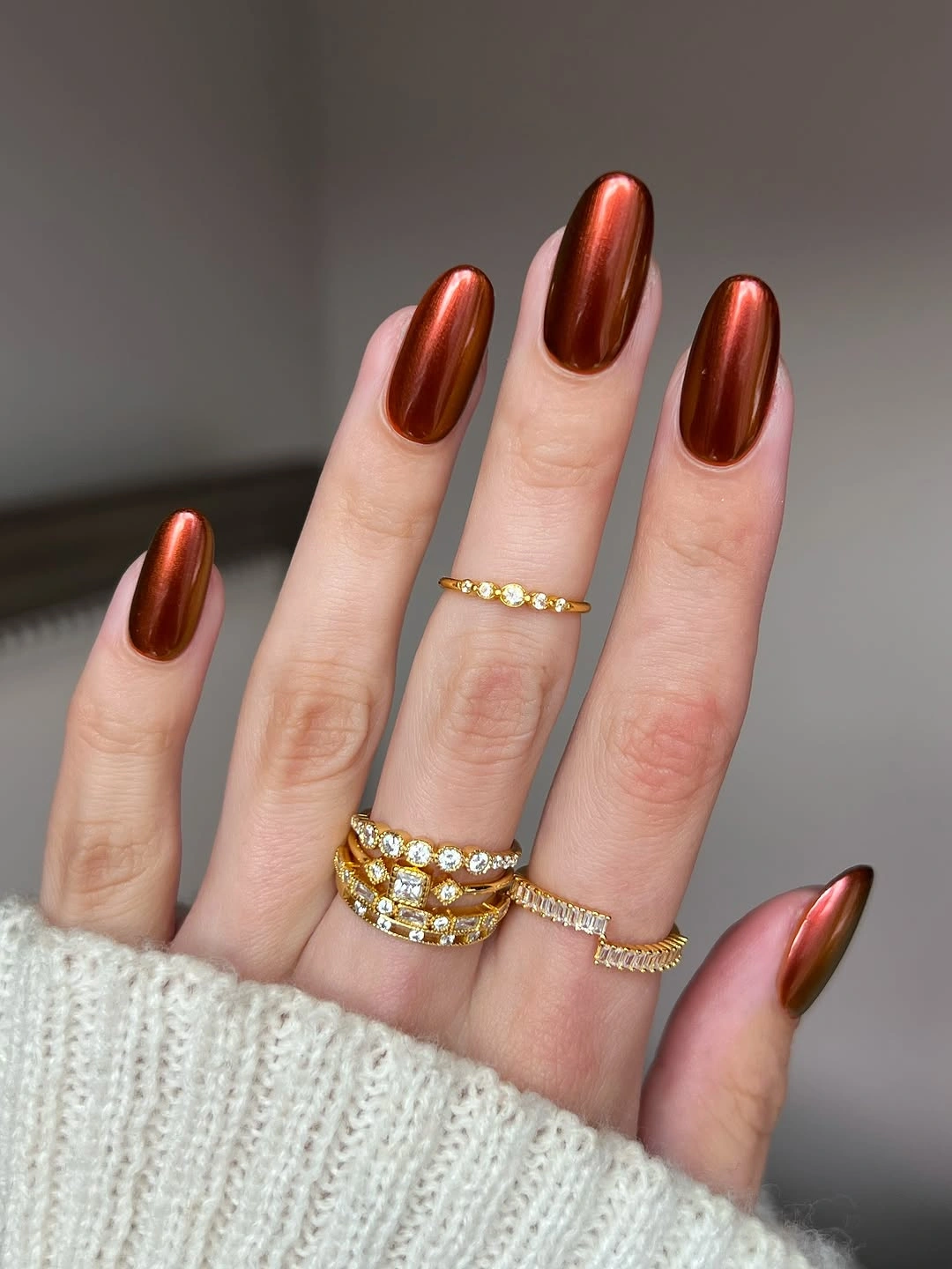Reflective copper brown almond nails with a clean glossy finish
