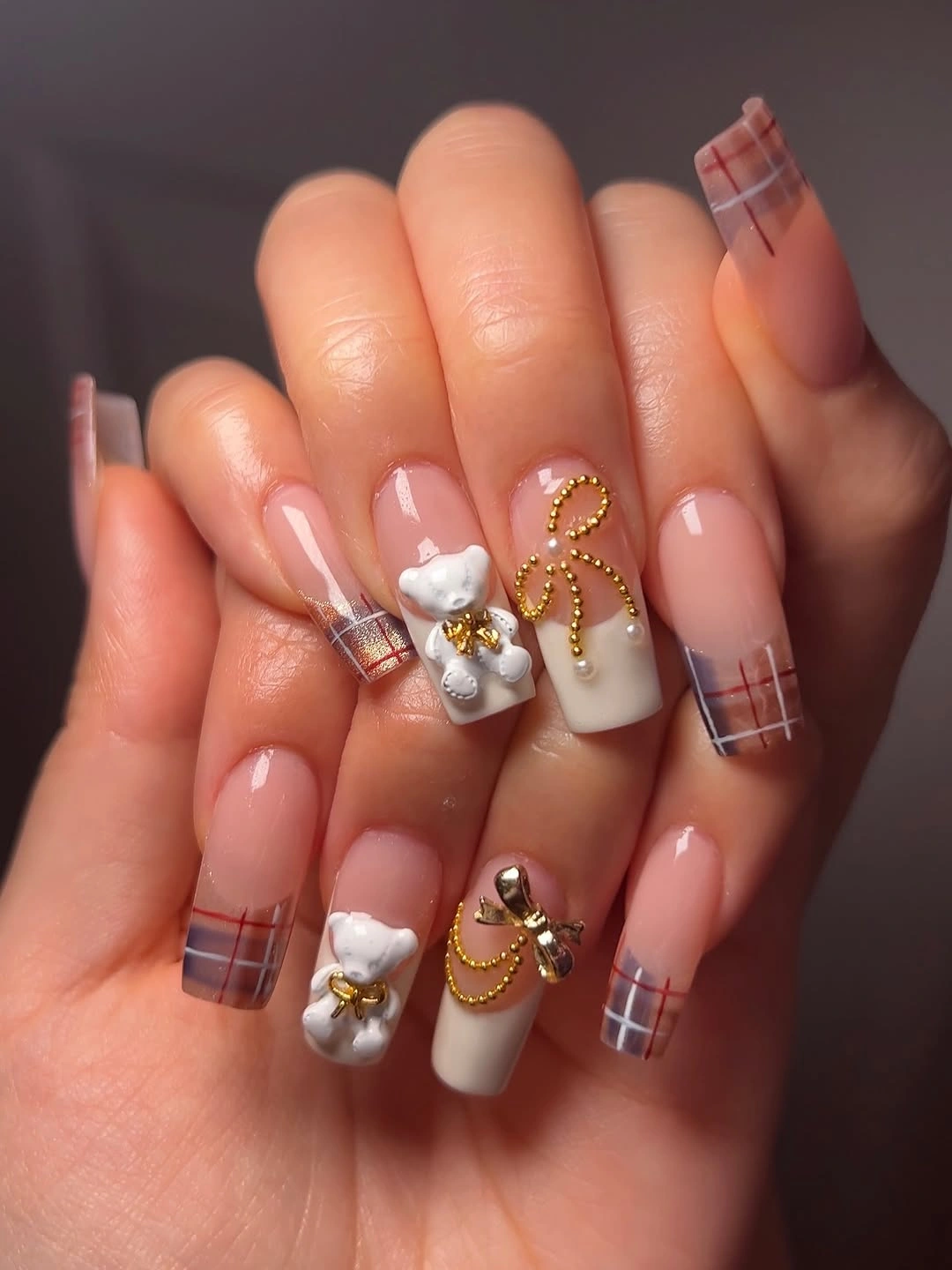 Square nude nails with plaid tips white accents and small bows