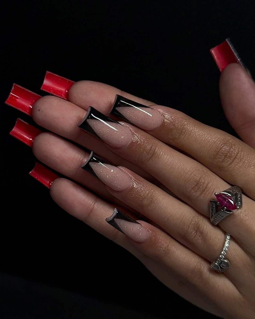 Tapered square nude nails with red tips and black graphic lines