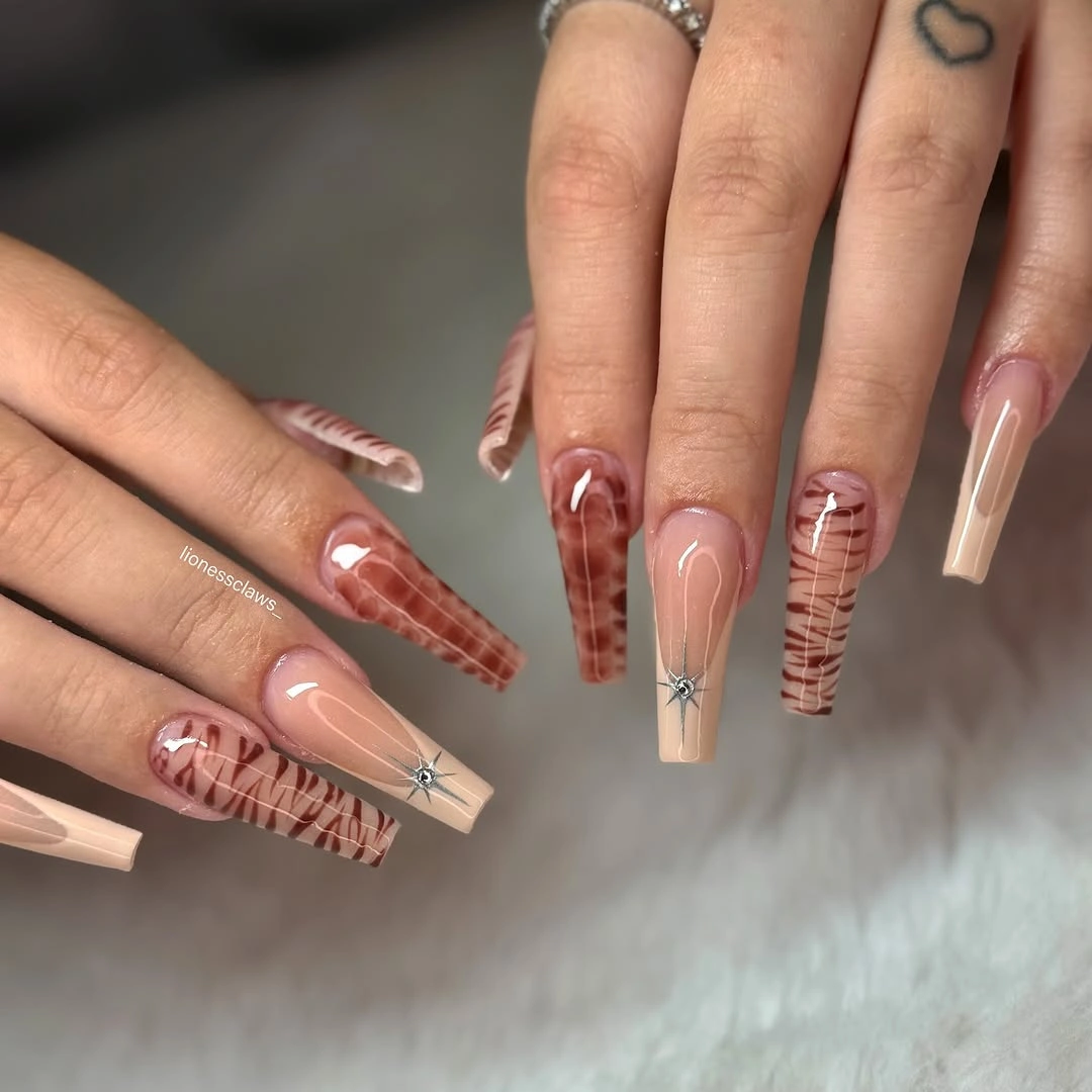 Medium coffin nude nails with brown plaid panels and tiny accents