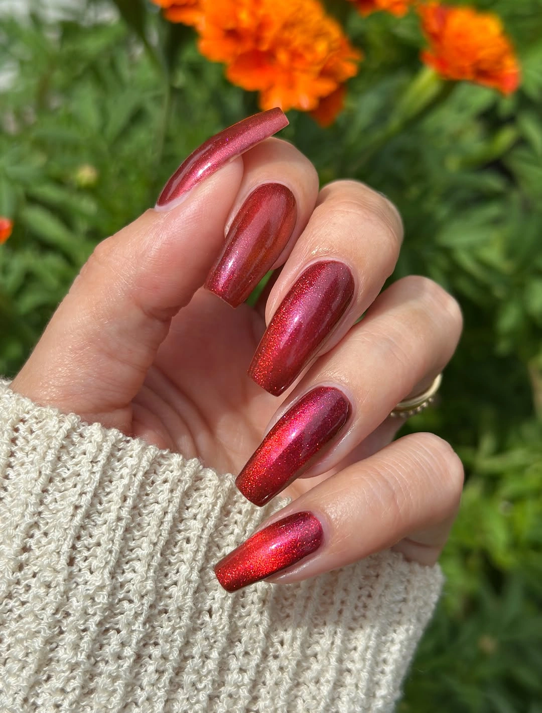 Burgundy almond nails with glossy reflective shine