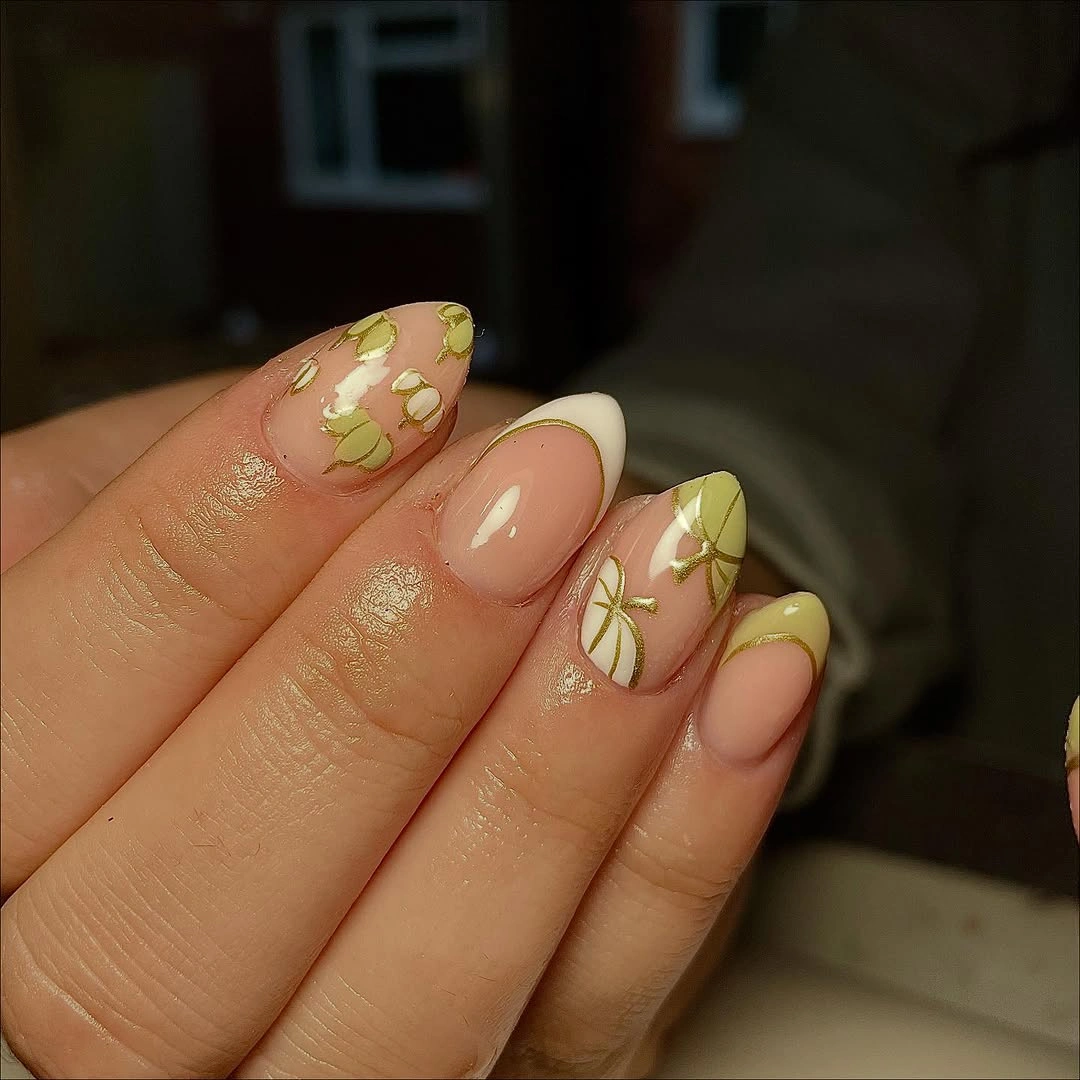 Nude almond nails with soft yellow floral tips