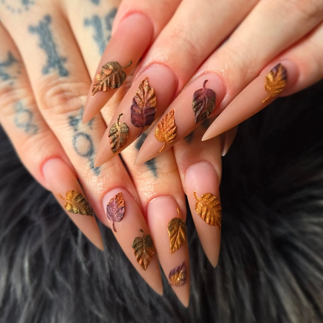 Warm almond nails with layered brown leaf art