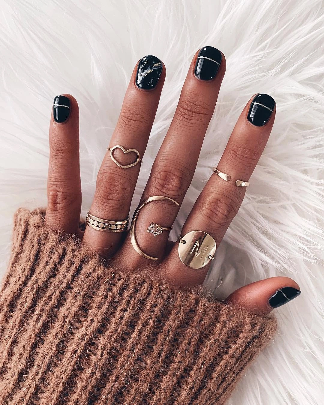 Glossy black square nails with tiny white accents