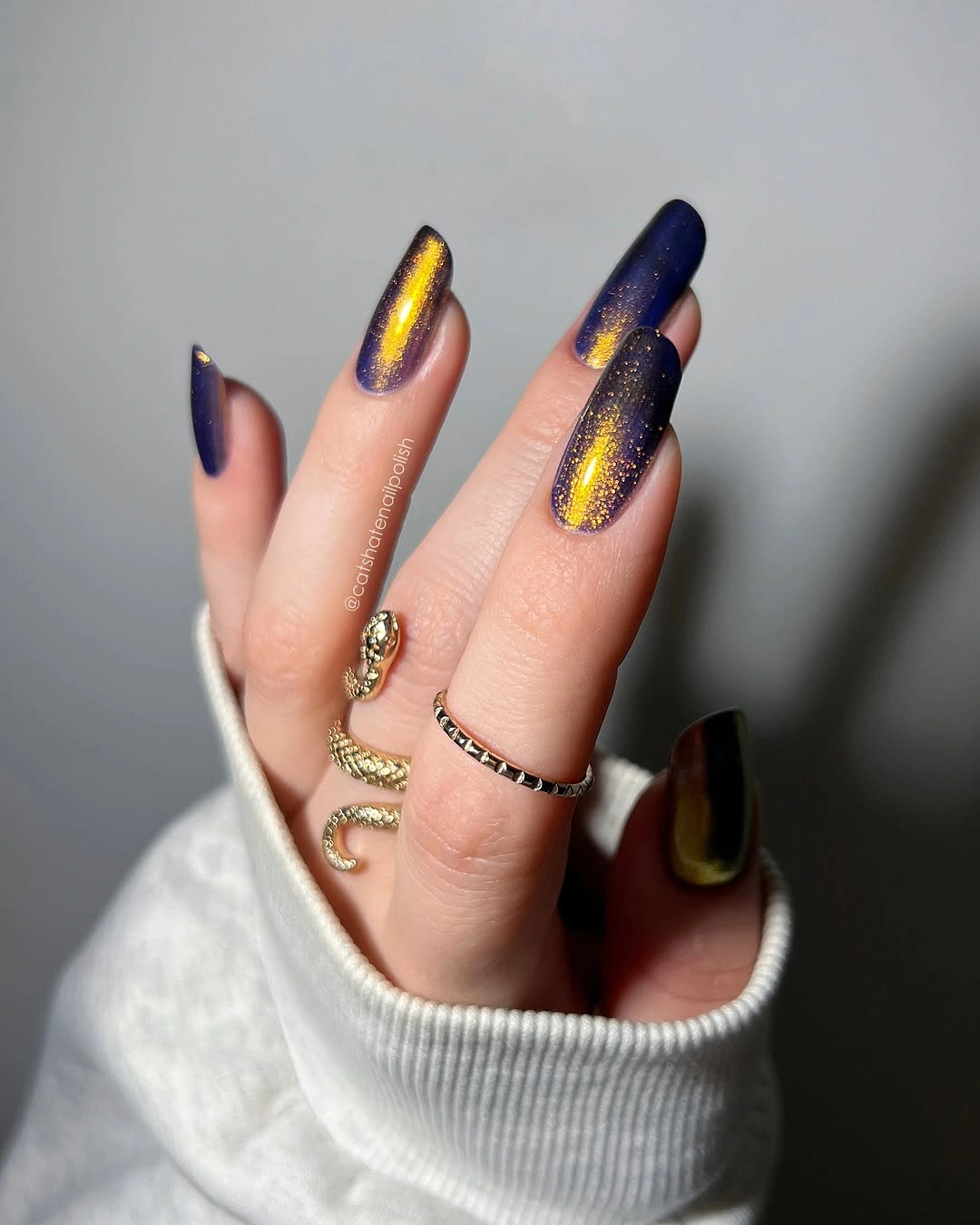 Dark coffin nails with gold metallic streak accents