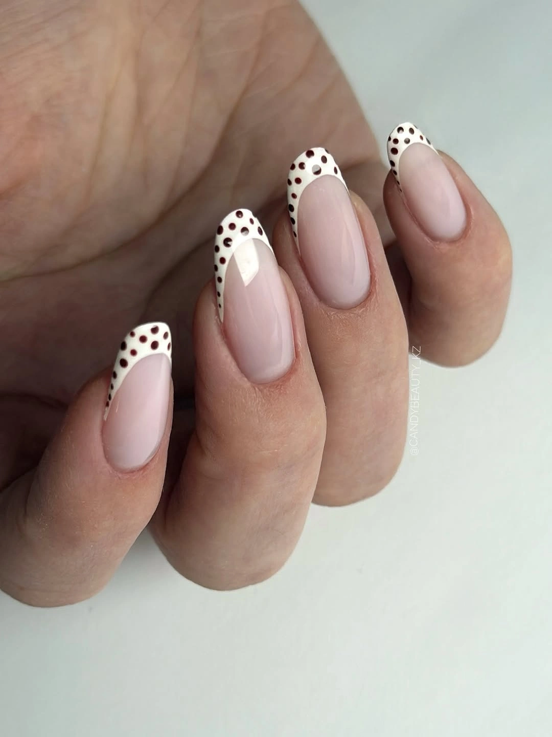 Medium almond nails with black spotted French tip edges