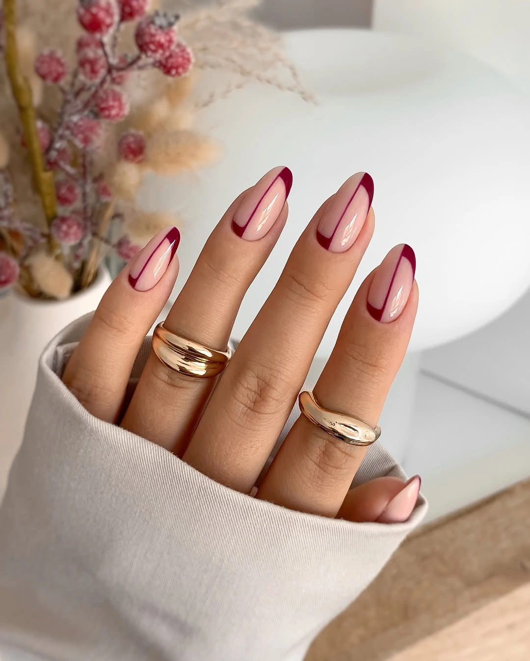 Medium almond nails with burgundy double French curves