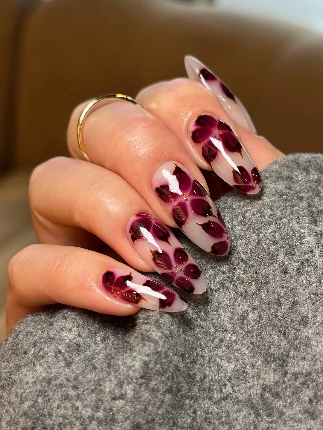 Medium almond nails with clustered burgundy accents and pale bases